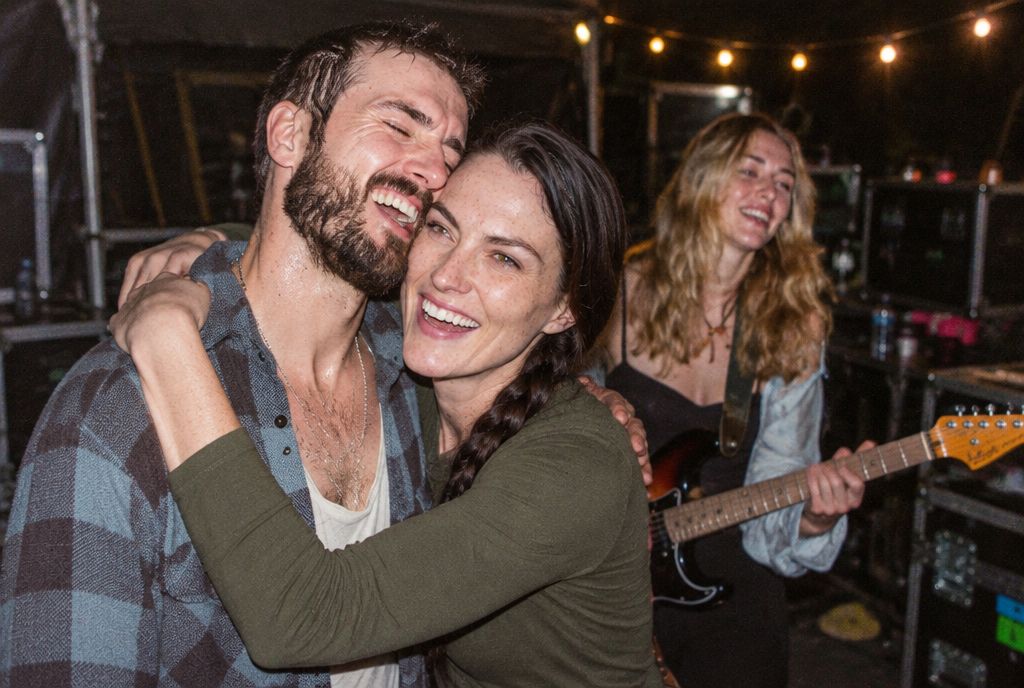 Tam laughing with the band backstage after a gig